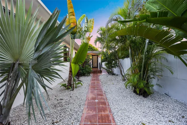 a large white kitchen with a stove a sink and a microwave