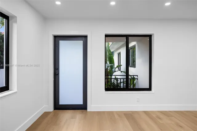 a view of a big room with windows and closet