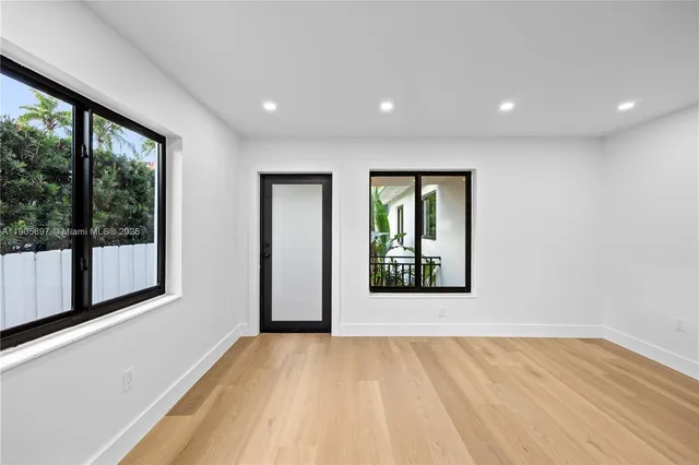 a view of a kitchen with a sink and a refrigerator