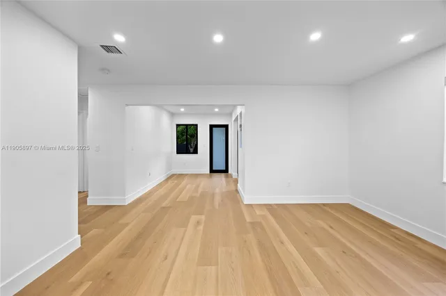 a kitchen with a sink dishwasher and a stove with wooden floor
