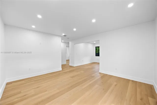 a kitchen with a refrigerator sink and cabinets