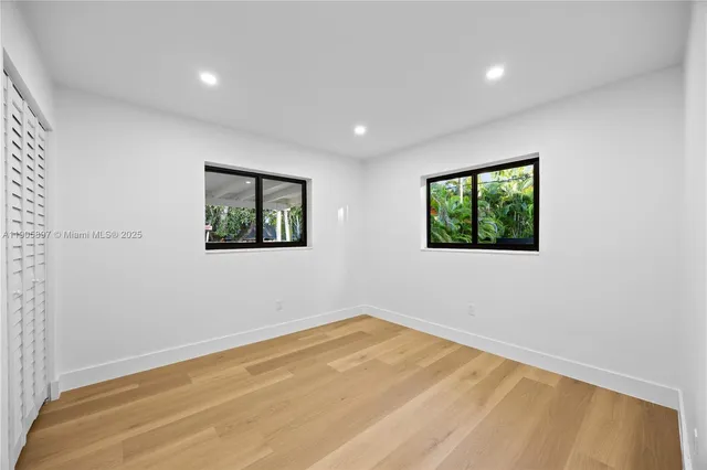 a view of a patio with table and chairs with wooden floor and fence