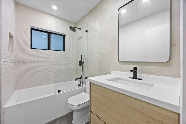 a bedroom with a large bed and a couch