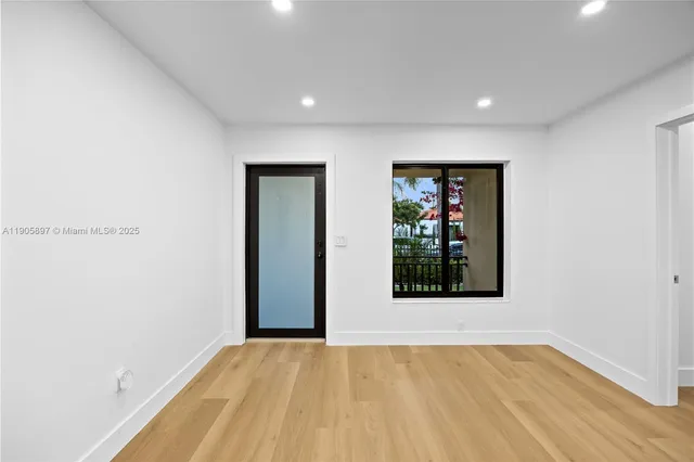 a kitchen with a sink a refrigerator and cabinets