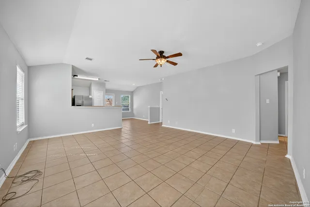 a view of an empty room with a ceiling fan