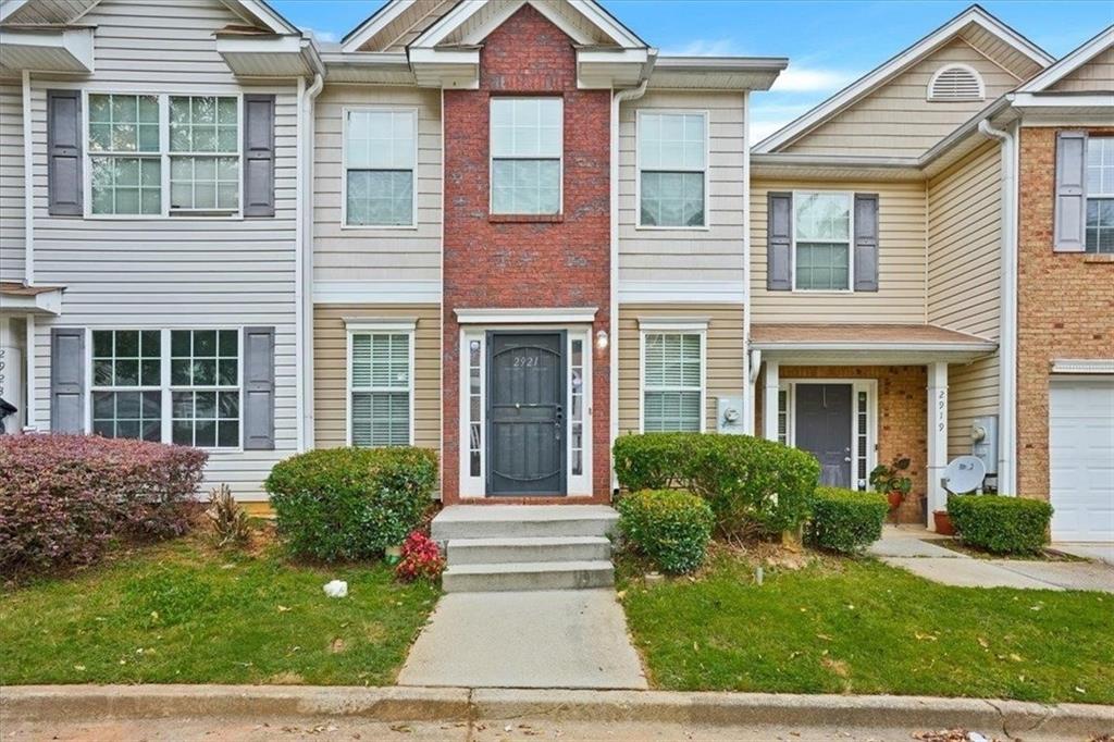 a view of a house with a small yard and plants