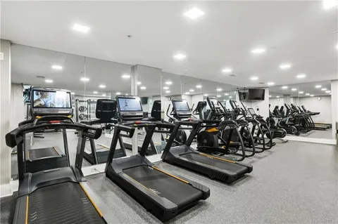 a media room with lots of chairs and mirrors
