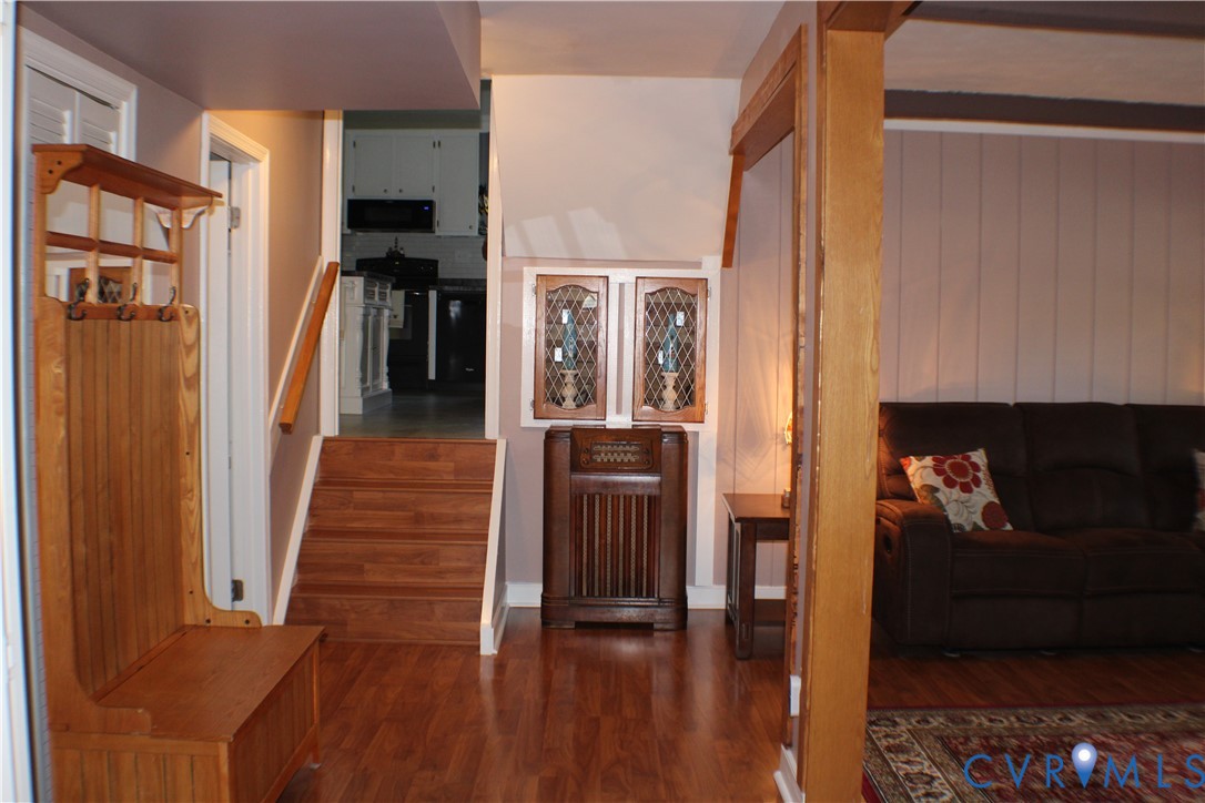 10009 Simplicity Street Chesterfield, VA 23832 - Photo 18 of 47 a view of a hallway with wooden floor and living room