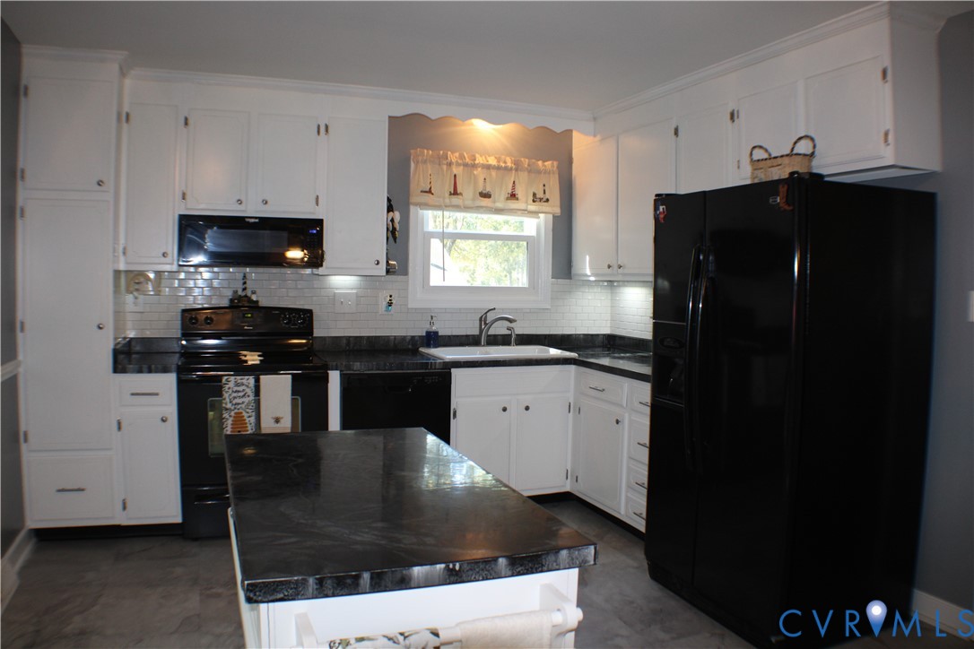 10009 Simplicity Street Chesterfield, VA 23832 - Photo 19 of 47 a kitchen with granite countertop a refrigerator a sink and a stove