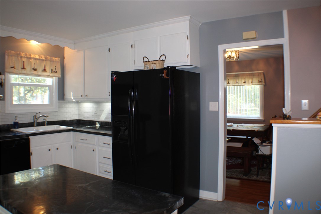 10009 Simplicity Street Chesterfield, VA 23832 - Photo 20 of 47 a kitchen with granite countertop a refrigerator a stove a sink and dishwasher with wooden cabinets