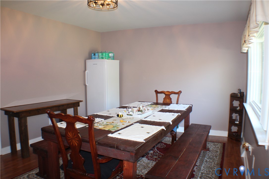 10009 Simplicity Street Chesterfield, VA 23832 - Photo 25 of 47 a view of a dining room with furniture and wooden floor