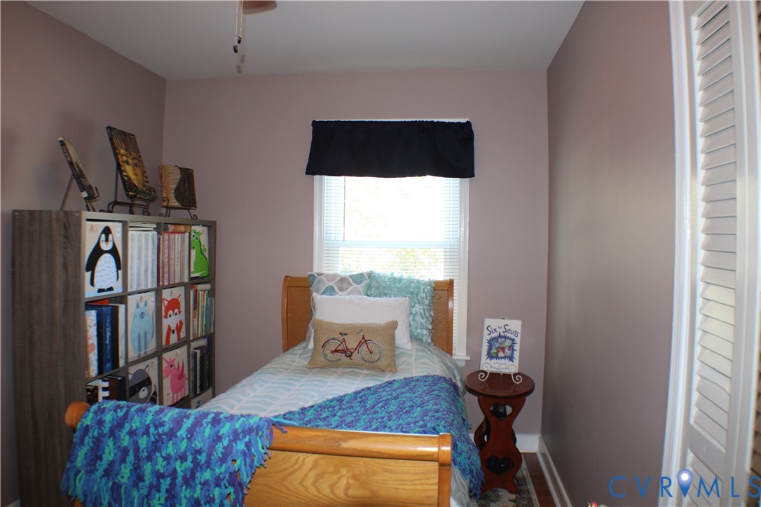 10009 Simplicity Street Chesterfield, VA 23832 - Photo 32 of 47 a bedroom with a bed and a book shelf