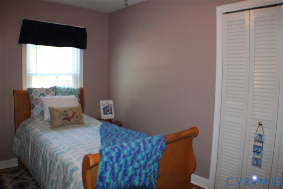 10009 Simplicity Street Chesterfield, VA 23832 - Photo 33 of 47 a bedroom with a bed and wooden floor