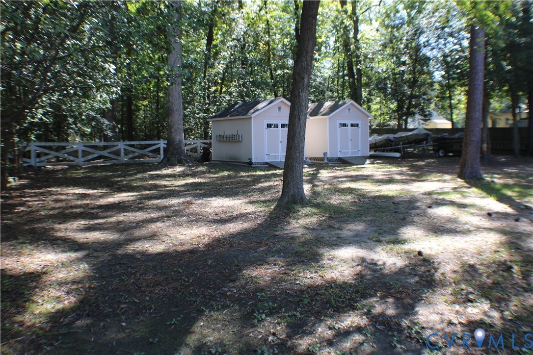 10009 Simplicity Street Chesterfield, VA 23832 - Photo 36 of 47 a backyard of a house with wooden fence and large trees