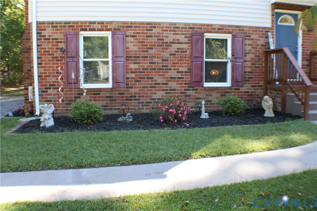 10009 Simplicity Street Chesterfield, VA 23832 - Photo 6 of 47 a view of a brick house with a yard and plants
