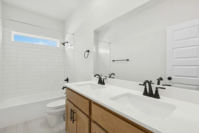 a bathroom with a sink a toilet and a tub