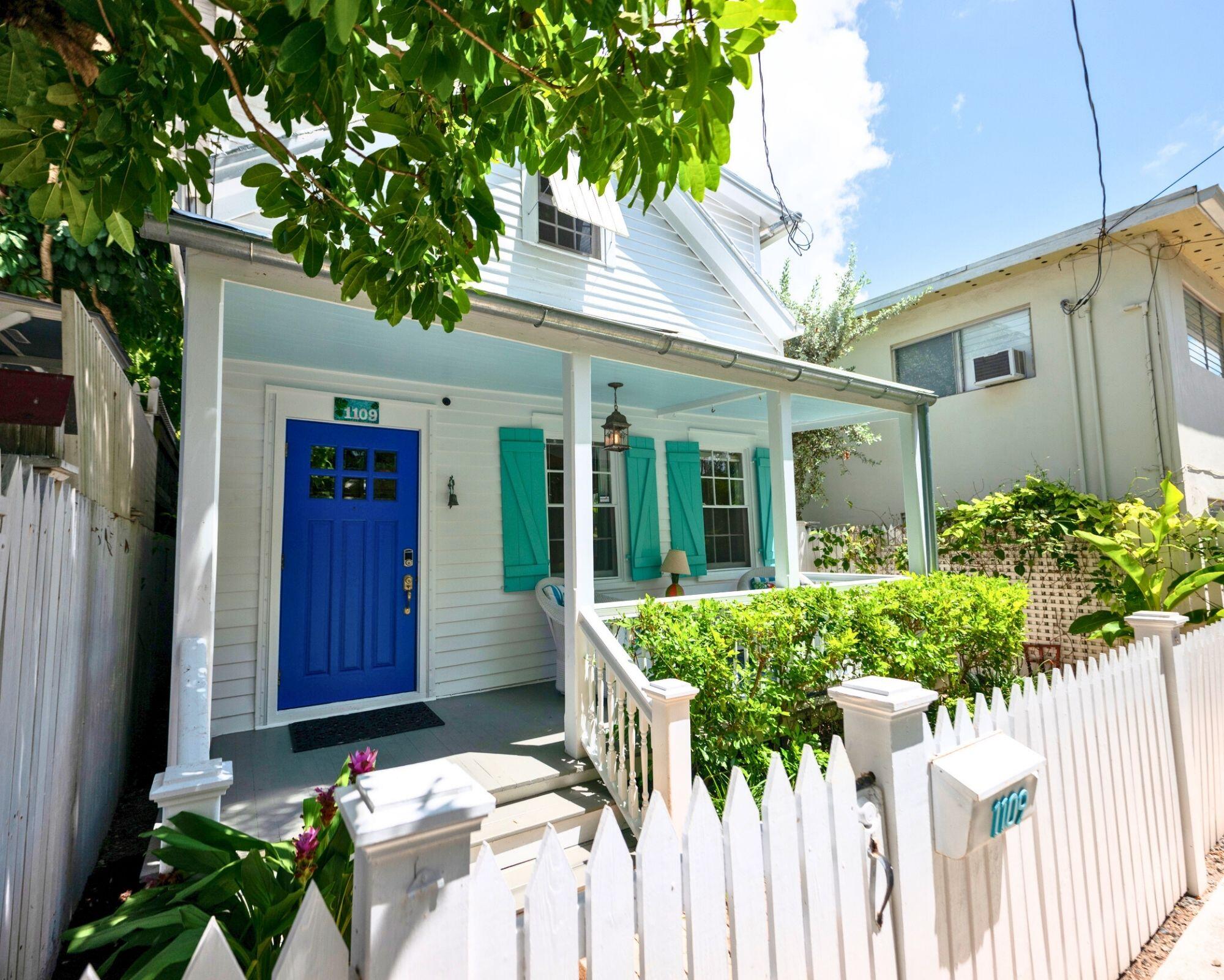 1109 Stump Lane Key West, FL 33040 - Photo 14 of 38 a view of a house with wooden walls potted plants
