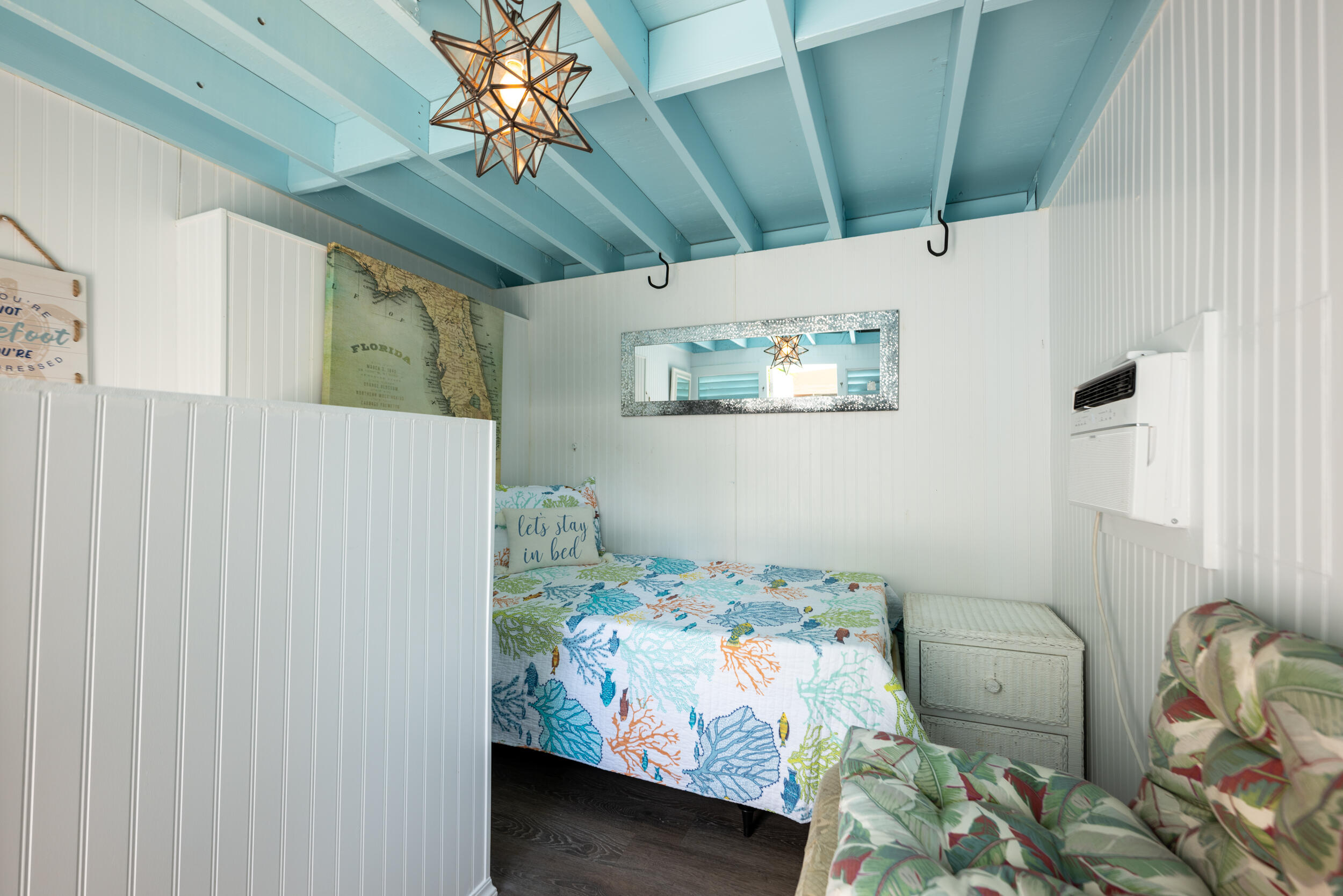 1109 Stump Lane Key West, FL 33040 - Photo 5 of 38 a bedroom with a bed and a chandelier