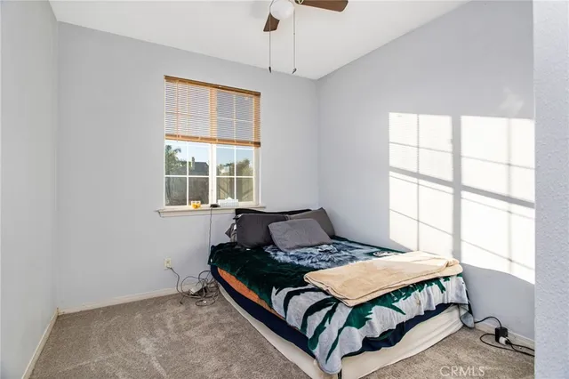 a bathroom with a toilet sink vanity and mirror