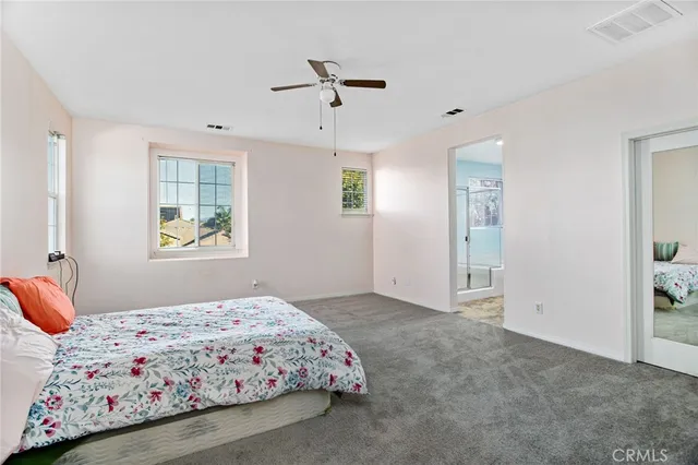 a spacious bathroom with a granite countertop sink and a mirror