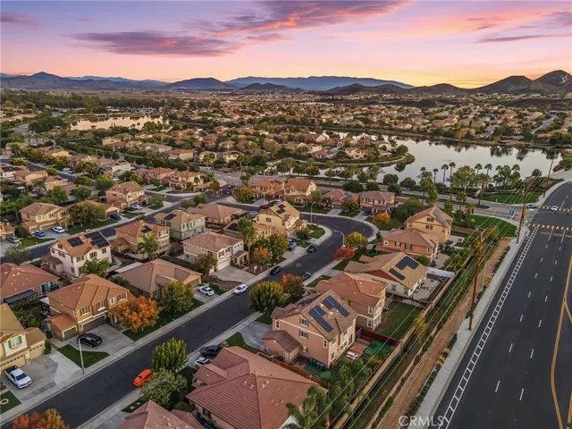 an aerial view of residential houses with city view