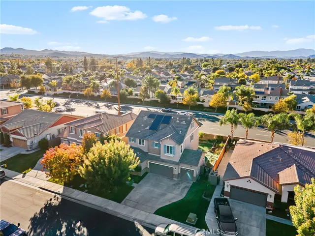 a view of a big yard in front of a brick house with a small yard