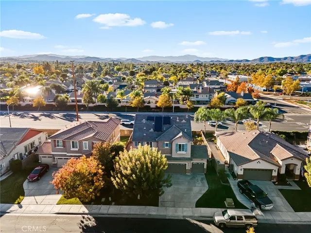 an aerial view of residential houses with outdoor space and lake view