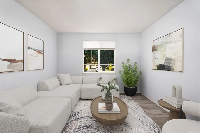 a living room with furniture and a potted plant