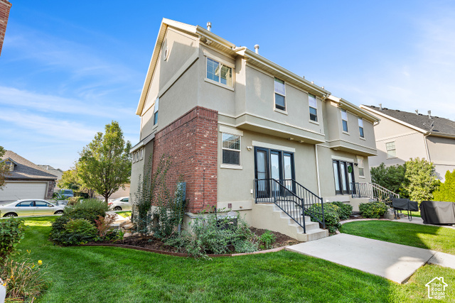 2092 Cres Drive South Mapleton, UT 84664 - Photo 24 of 26 Stucco exterior featuring red brick accents, multiple windows, and two sets of double glass doors