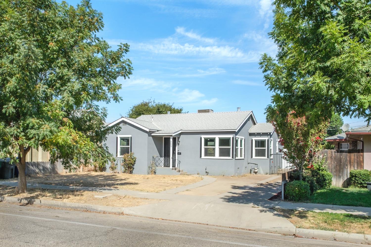 2043 11th Street Reedley, CA 93654 - Photo 15 of 21 a front view of a house with a garden