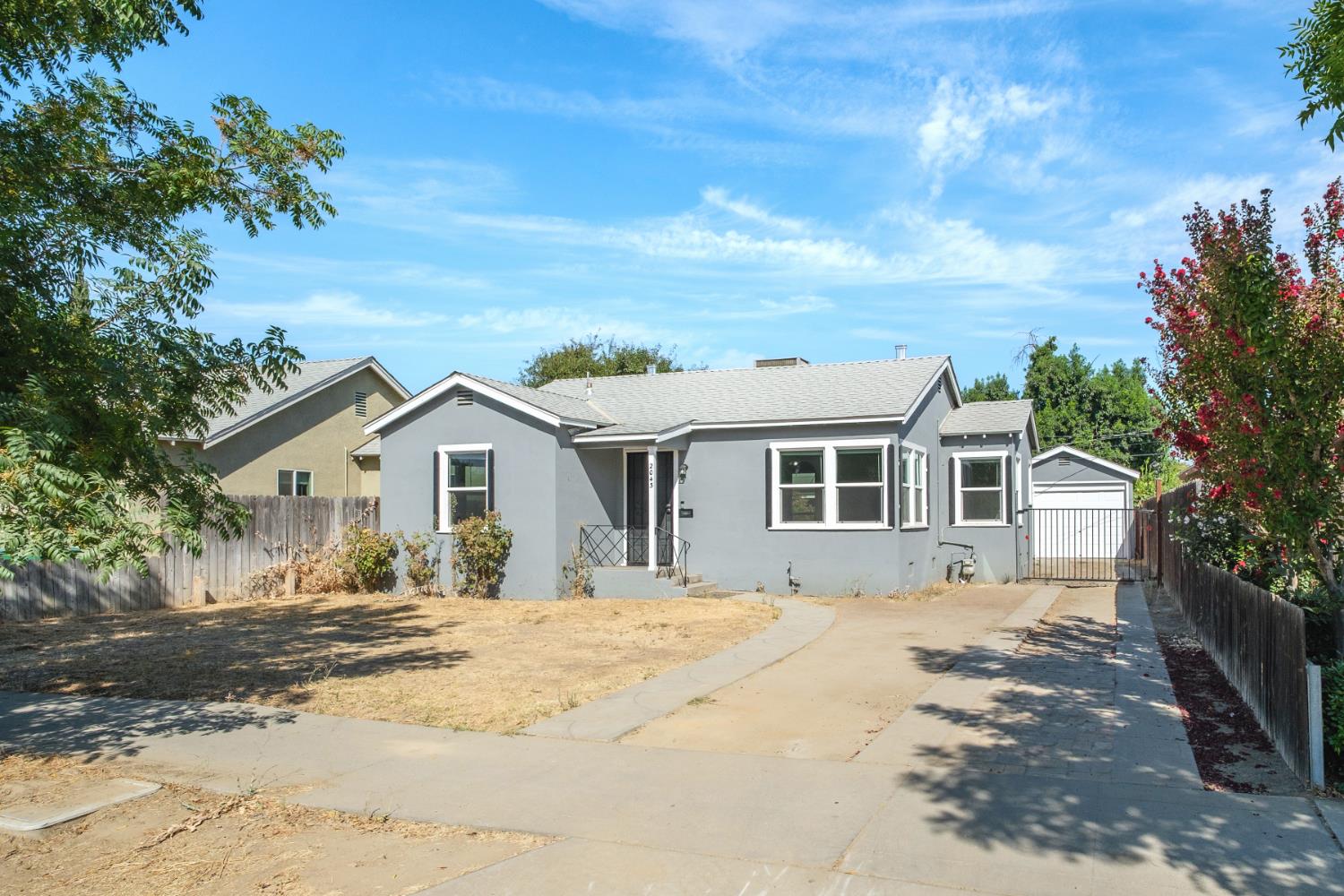 2043 11th Street Reedley, CA 93654 - Photo 19 of 21 a front view of a house with a yard