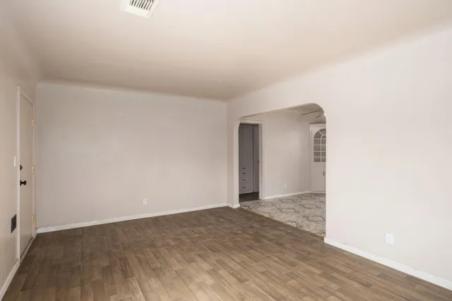 a view of an empty room and wooden floor