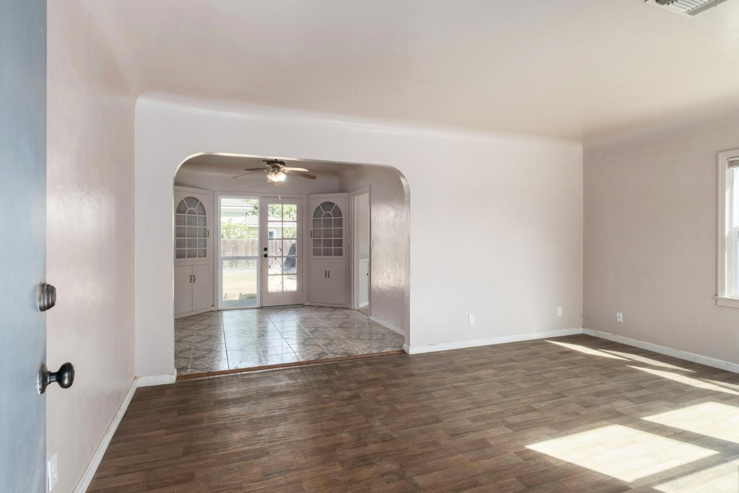 2043 11th Street Reedley, CA 93654 - Photo 4 of 21 a view of empty room with wooden floor and fan