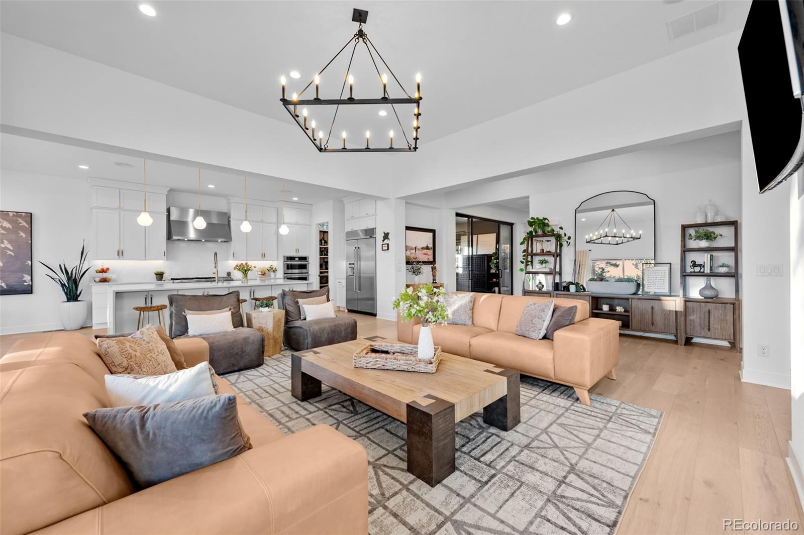 6001 Powell Road Parker, CO 80134 - Photo 12 of 50 a living room with furniture kitchen view and a chandelier