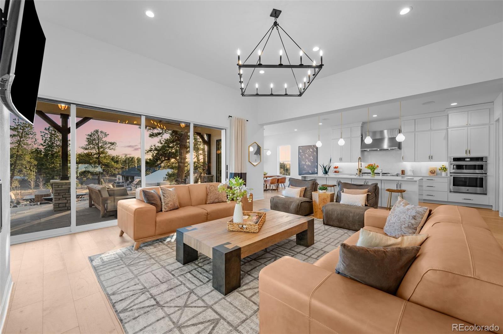 6001 Powell Road Parker, CO 80134 - Photo 13 of 50 a living room with furniture a chandelier and a large window