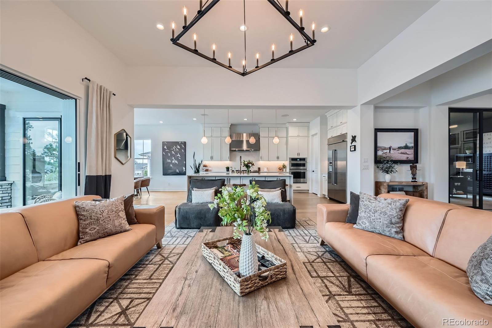 6001 Powell Road Parker, CO 80134 - Photo 14 of 50 a living room with furniture wooden floor and a chandelier