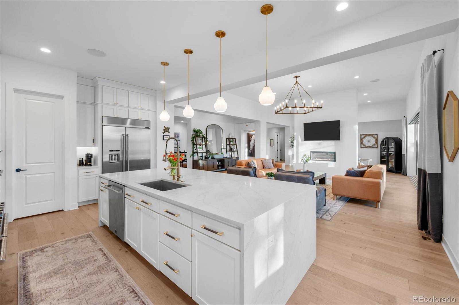 6001 Powell Road Parker, CO 80134 - Photo 20 of 50 a large white kitchen with a large island oven and a sink