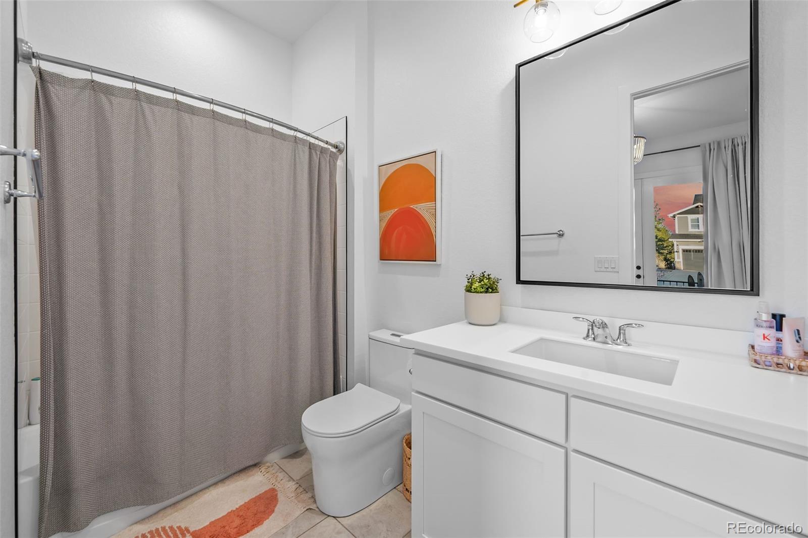 6001 Powell Road Parker, CO 80134 - Photo 35 of 50 a bathroom with a sink and a mirror