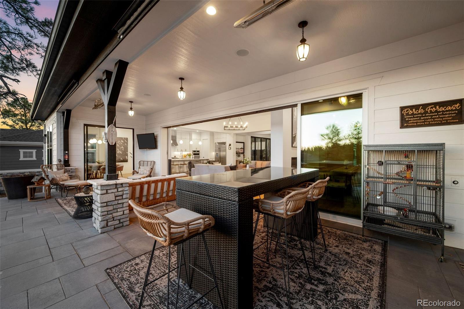 6001 Powell Road Parker, CO 80134 - Photo 39 of 50 a room with furniture a rug and a chandelier