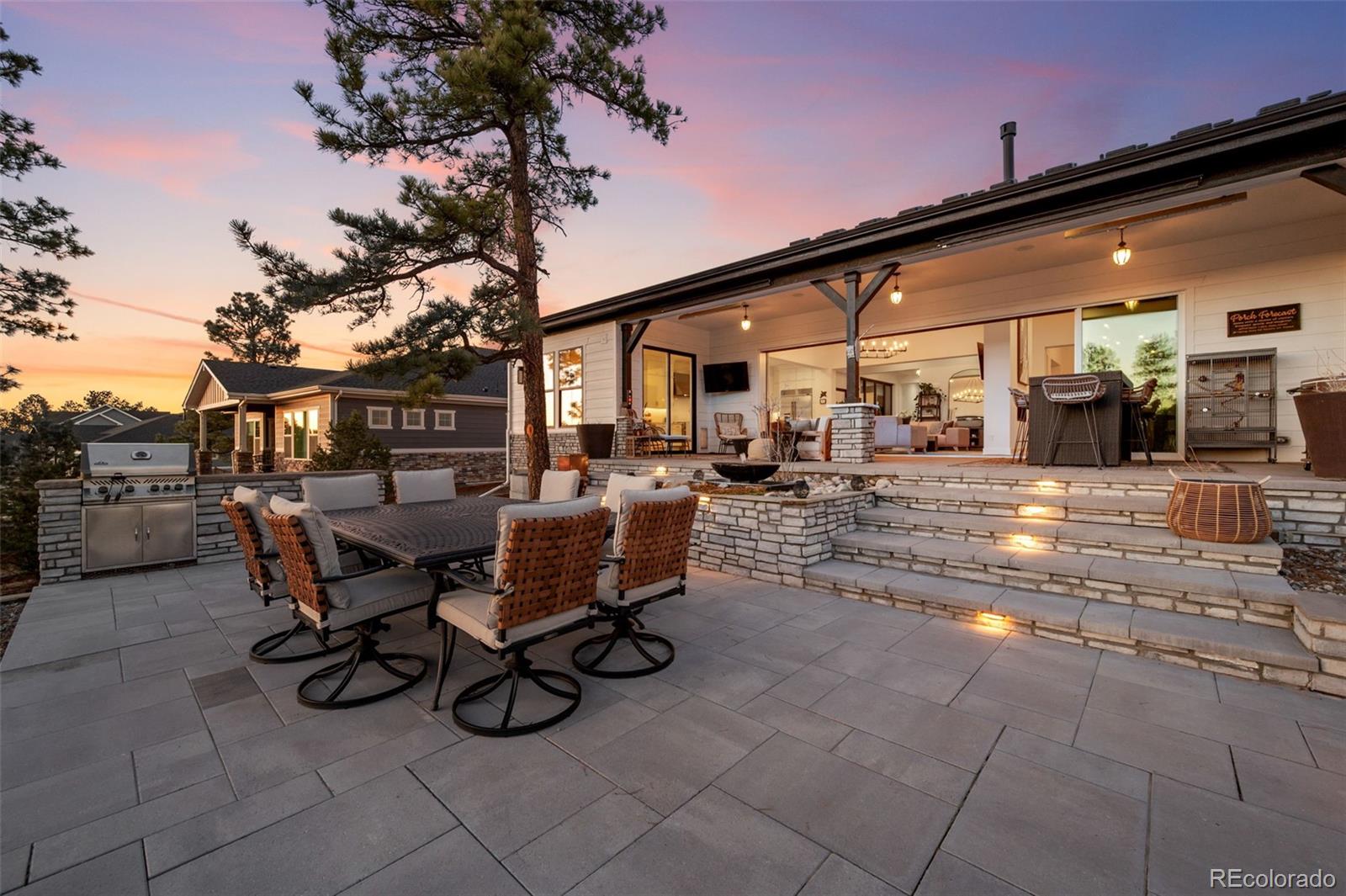 6001 Powell Road Parker, CO 80134 - Photo 44 of 50 a view of a patio with dining table and chairs with wooden fence