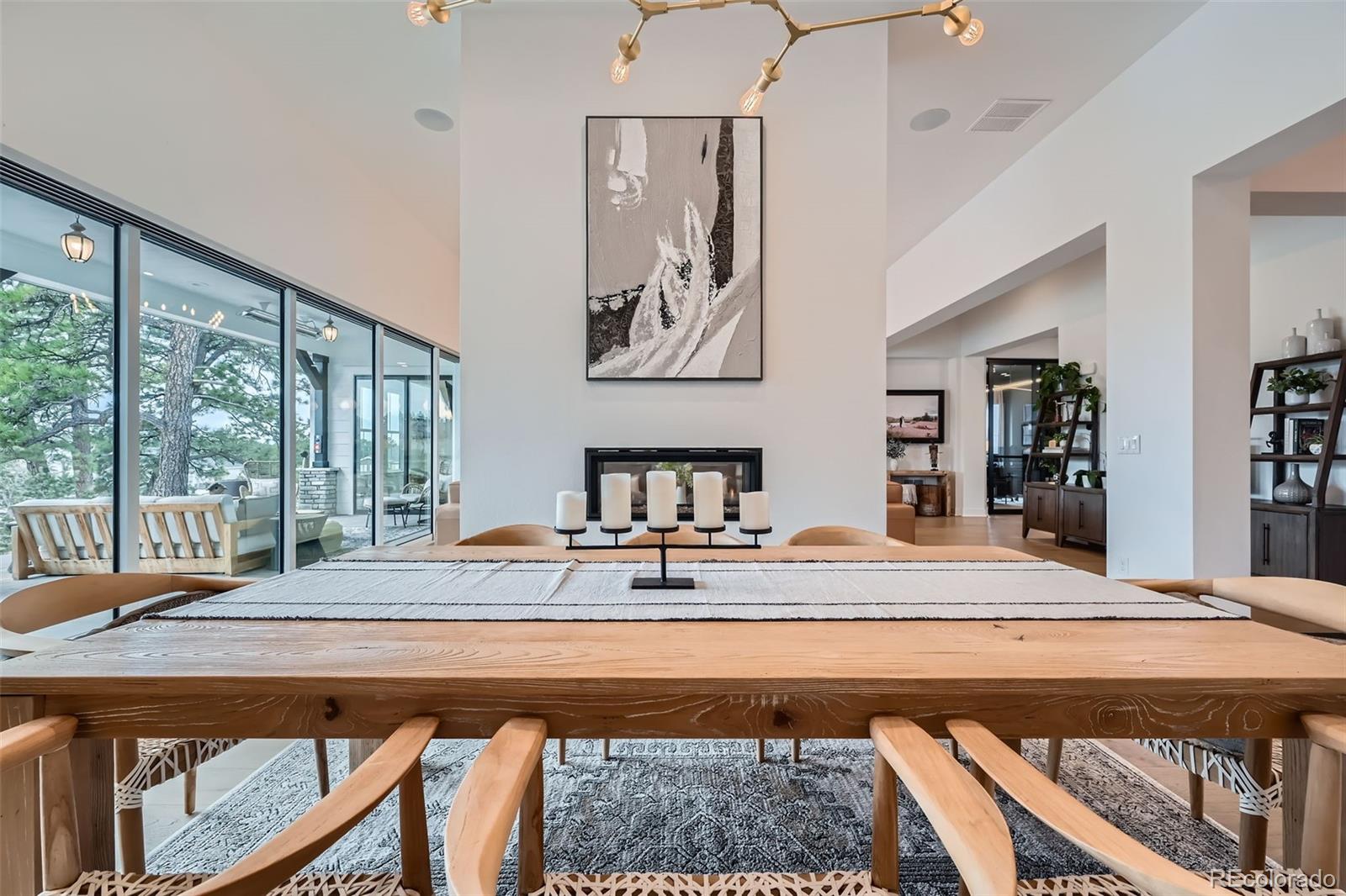 6001 Powell Road Parker, CO 80134 - Photo 9 of 50 a living room with a table and paintings on the wall