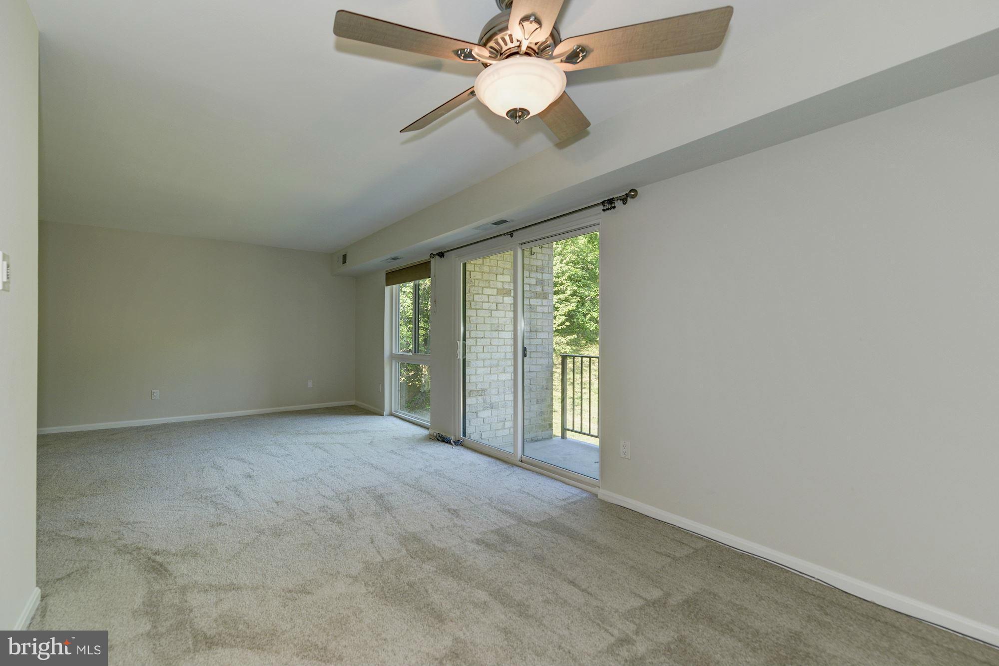 6155 Edsall Road, Unit H Alexandria, VA 22304 - Photo 12 of 30 an empty room with a ceiling fan and a large window