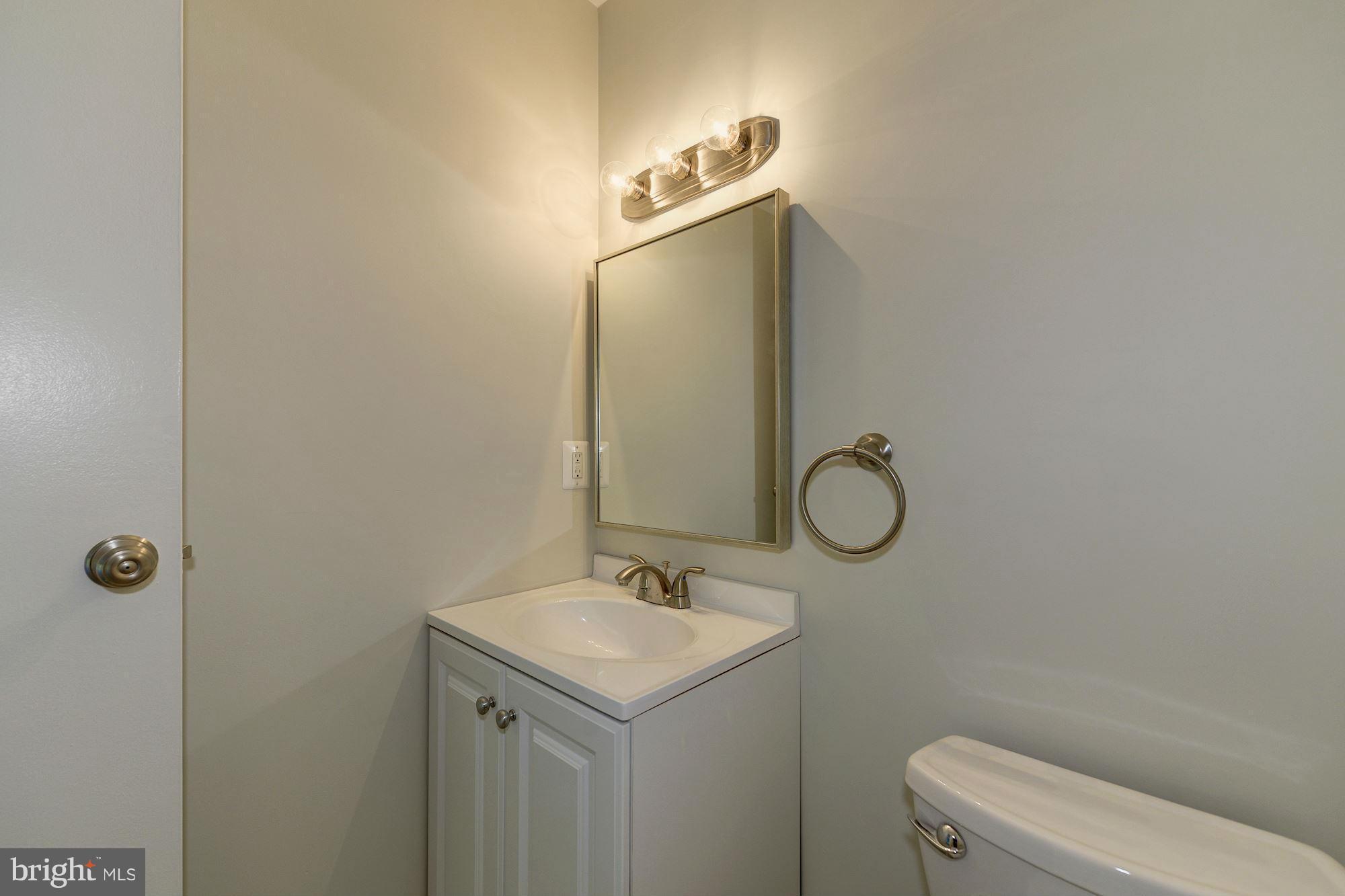 6155 Edsall Road, Unit H Alexandria, VA 22304 - Photo 21 of 30 a bathroom with a granite countertop toilet sink and mirror