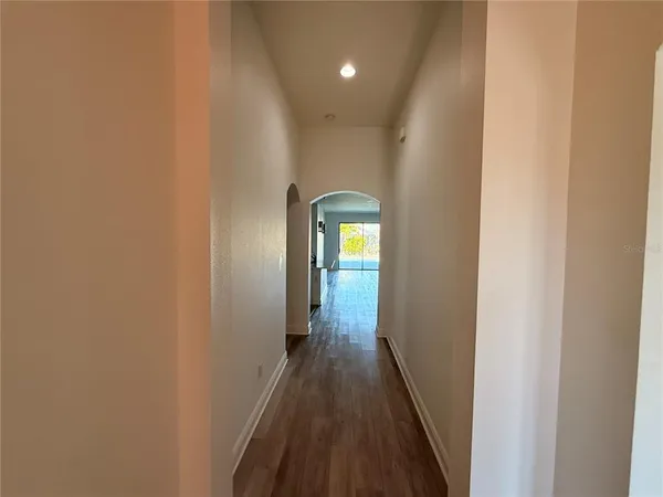 a view of a hallway with wooden floor