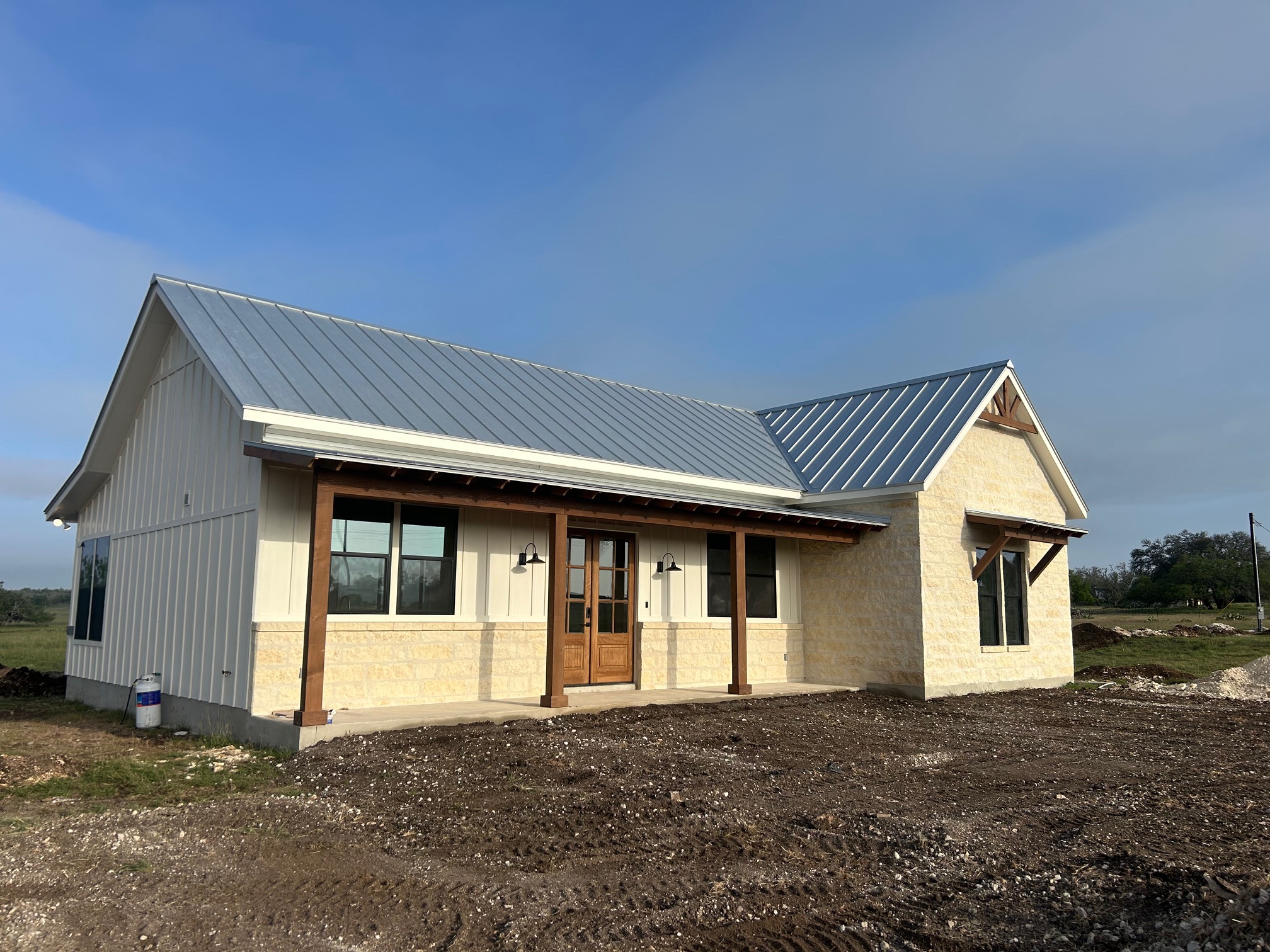 68 South Ranch Rd Roads South Harper, TX 78631 - Photo 1 of 1 Modern inspired farmhouse featuring metal roof, stone siding, french doors, and board and batten siding