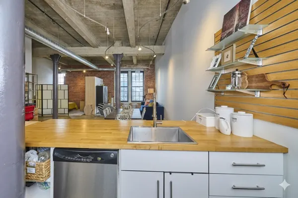 a view of a kitchen with a sink and chandelier