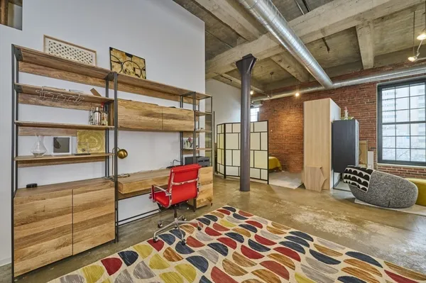 a bedroom with furniture and a window