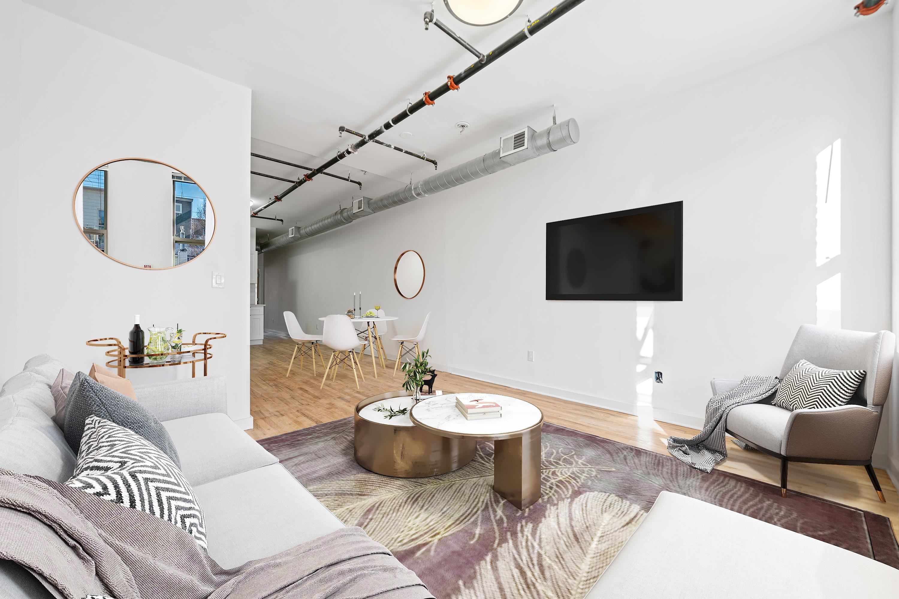 615 Monroe Street, Unit 1 Hoboken, NJ 07030 - Photo 2 of 10 a living room with furniture a flat screen tv and a dining table