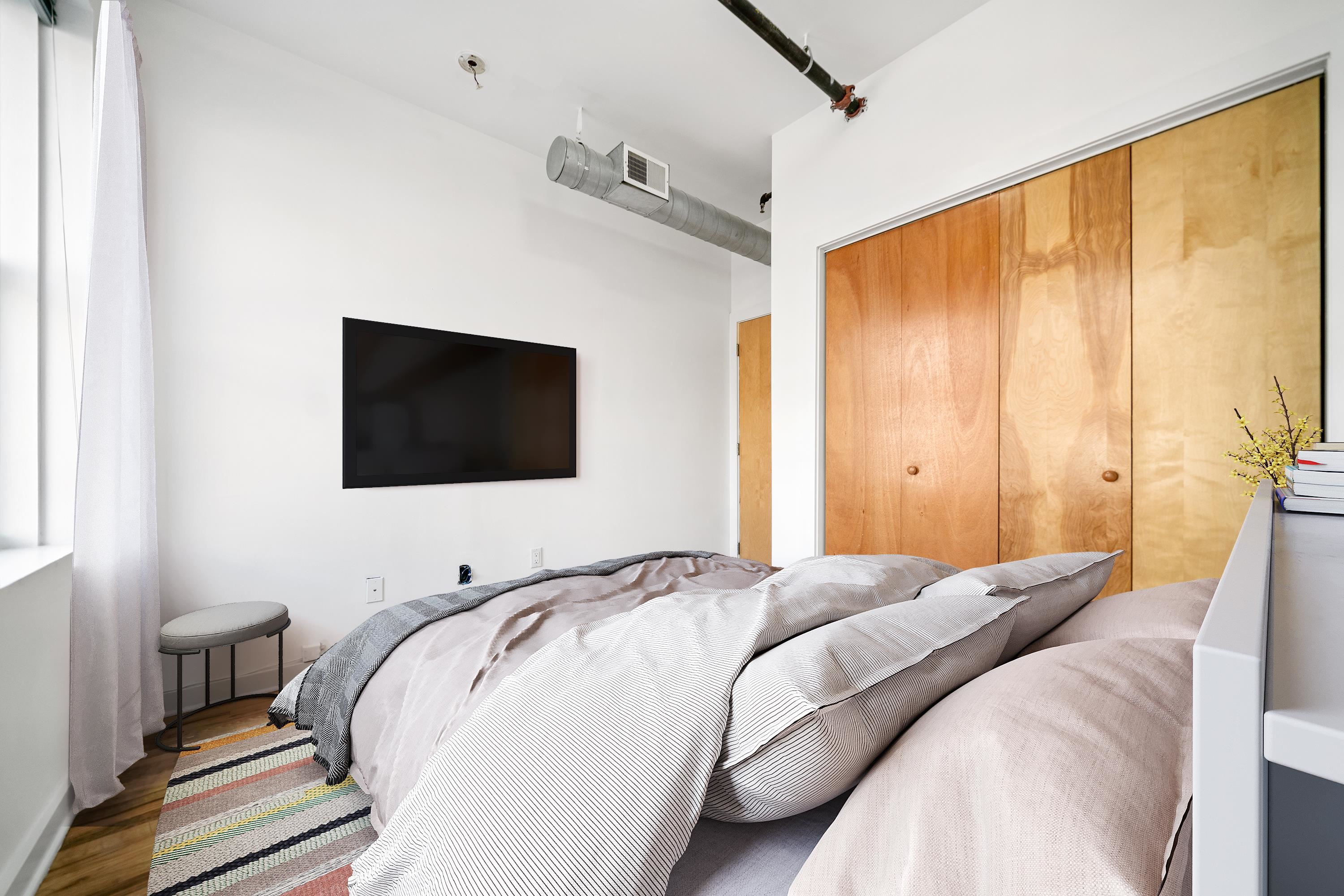 615 Monroe Street, Unit 1 Hoboken, NJ 07030 - Photo 5 of 10 a bedroom with a bed and a flat screen tv