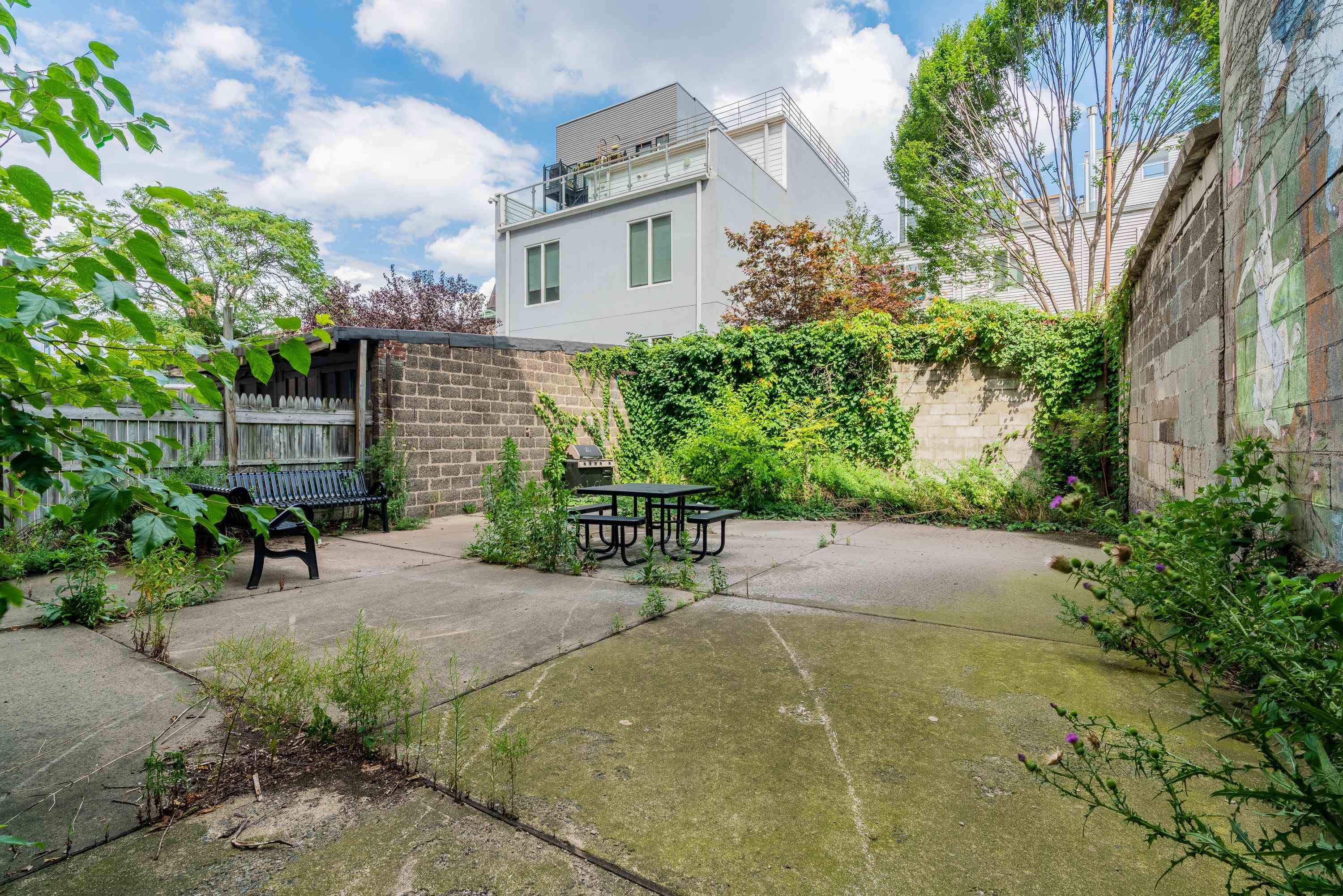 615 Monroe Street, Unit 1 Hoboken, NJ 07030 - Photo 7 of 10 a view of a backyard with plants and a patio